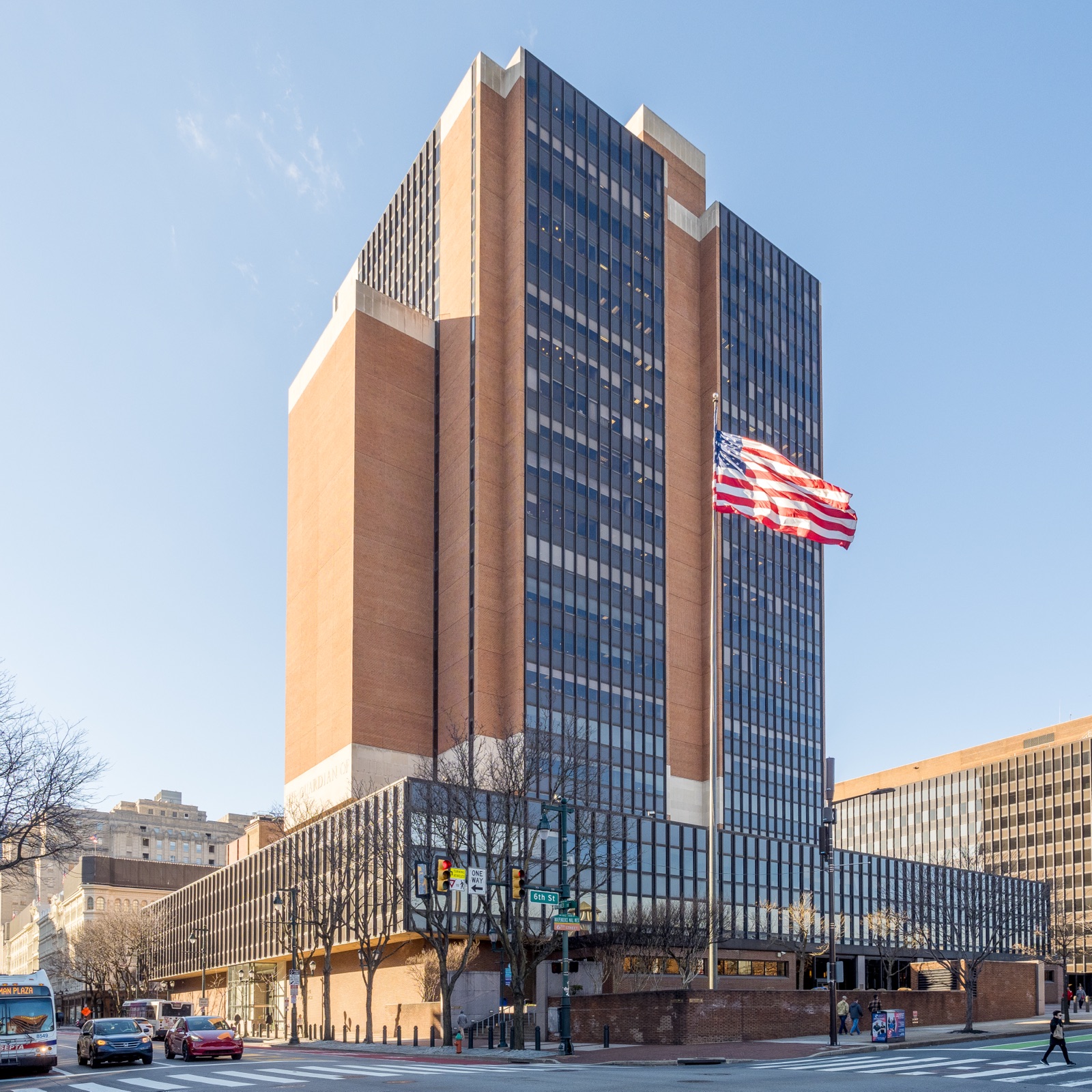The James A. Byrne U.S. Courthouse in Philadelphia, a tall brick and dark-glass tower with an American flag in front