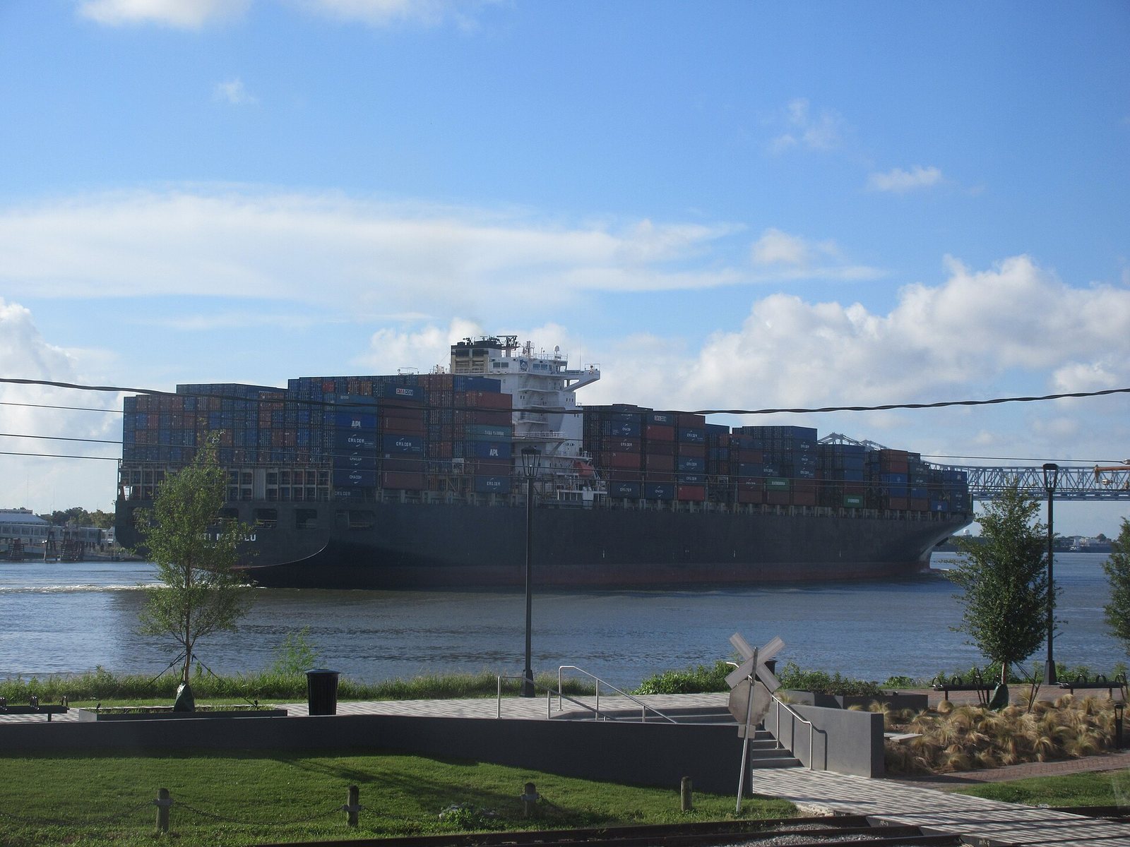 A large container ship stacked with cargo on the Mississippi River at New Orleans