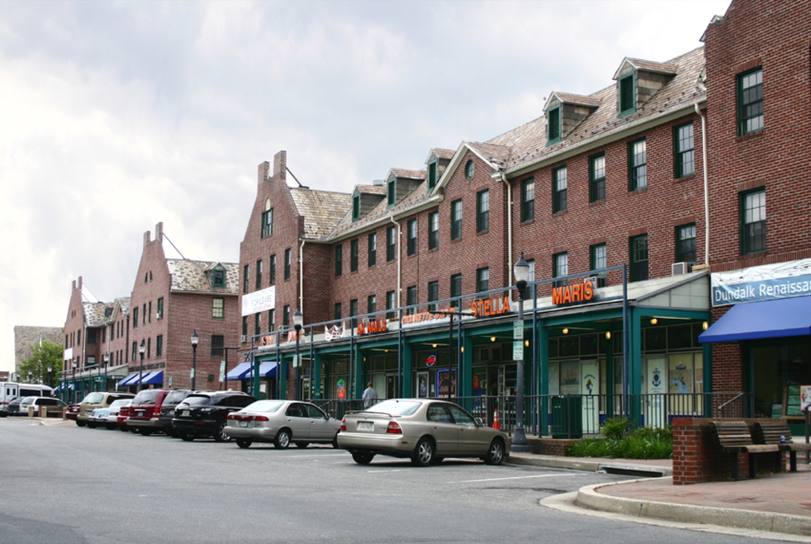 Brick storefront buildings with green awnings at the Dundalk Shopping Center in Dundalk, Maryland