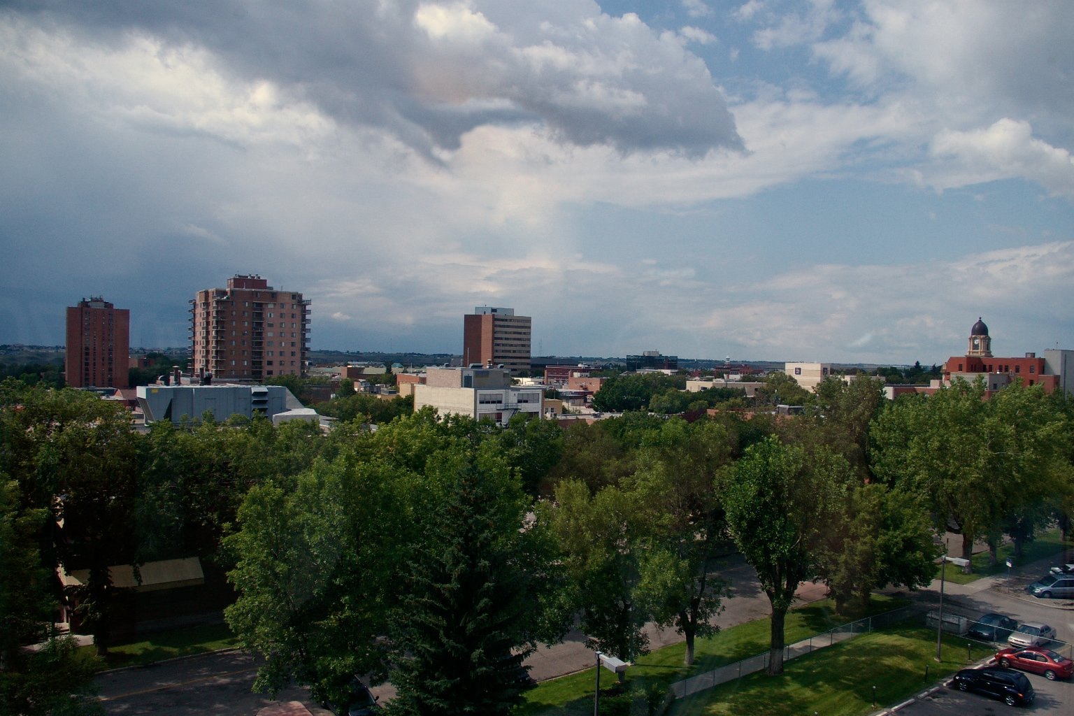 Downtown Lethbridge, Alberta, seen from above, with apartment towers and trees