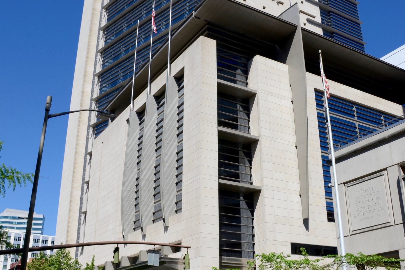 The Mark O. Hatfield U.S. Courthouse in downtown Portland, Oregon, with flags at its entrance