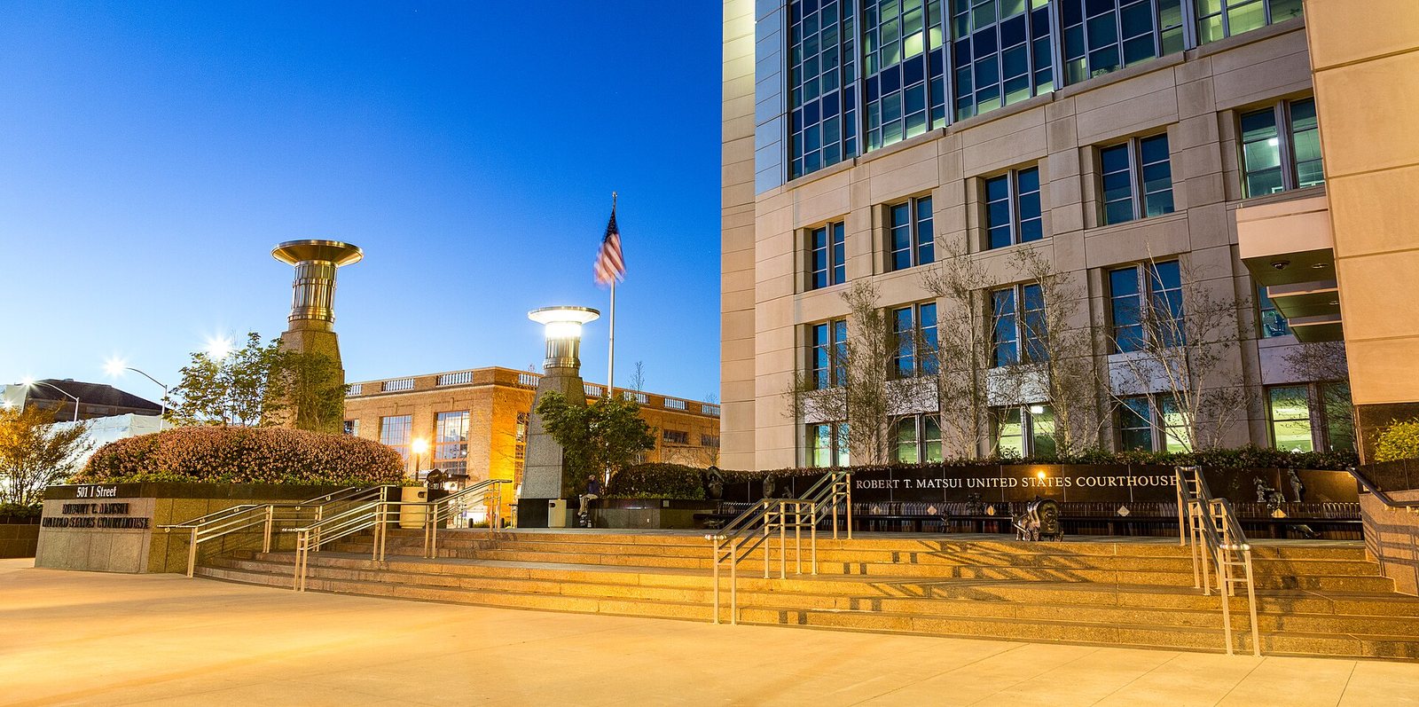 Robert T. Matsui United States Courthouse in Sacramento at dusk, its name on the plaza wall