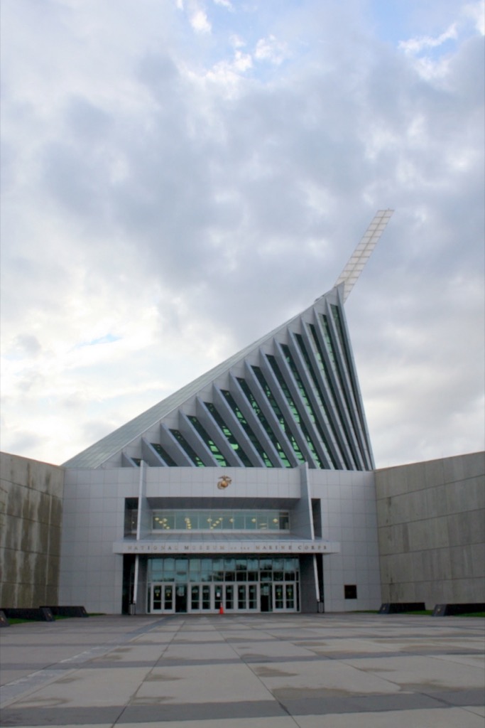 The tilted steel spire of the National Museum of the Marine Corps against a blue sky