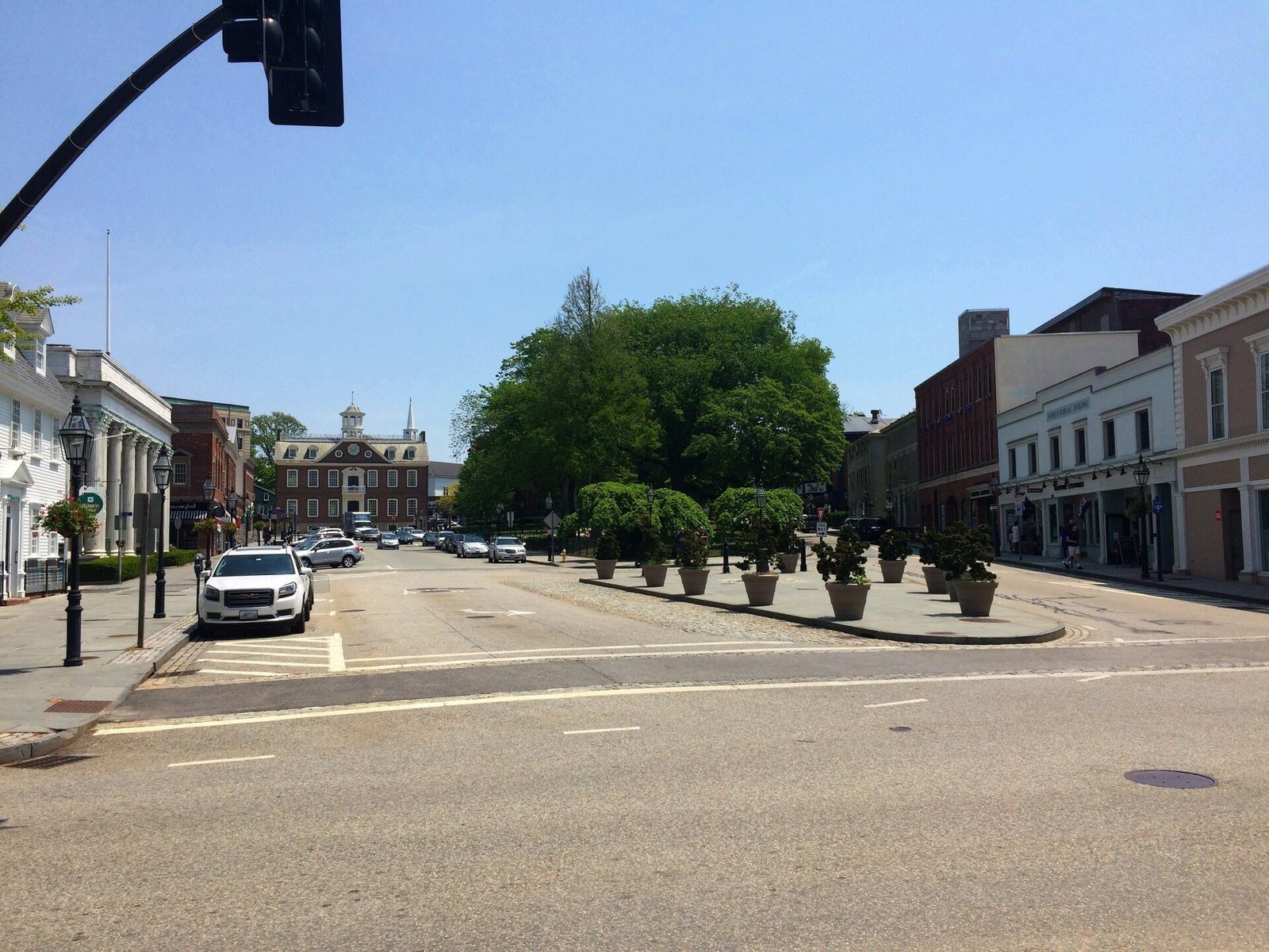 A downtown street in Newport, Rhode Island, with historic buildings and planters
