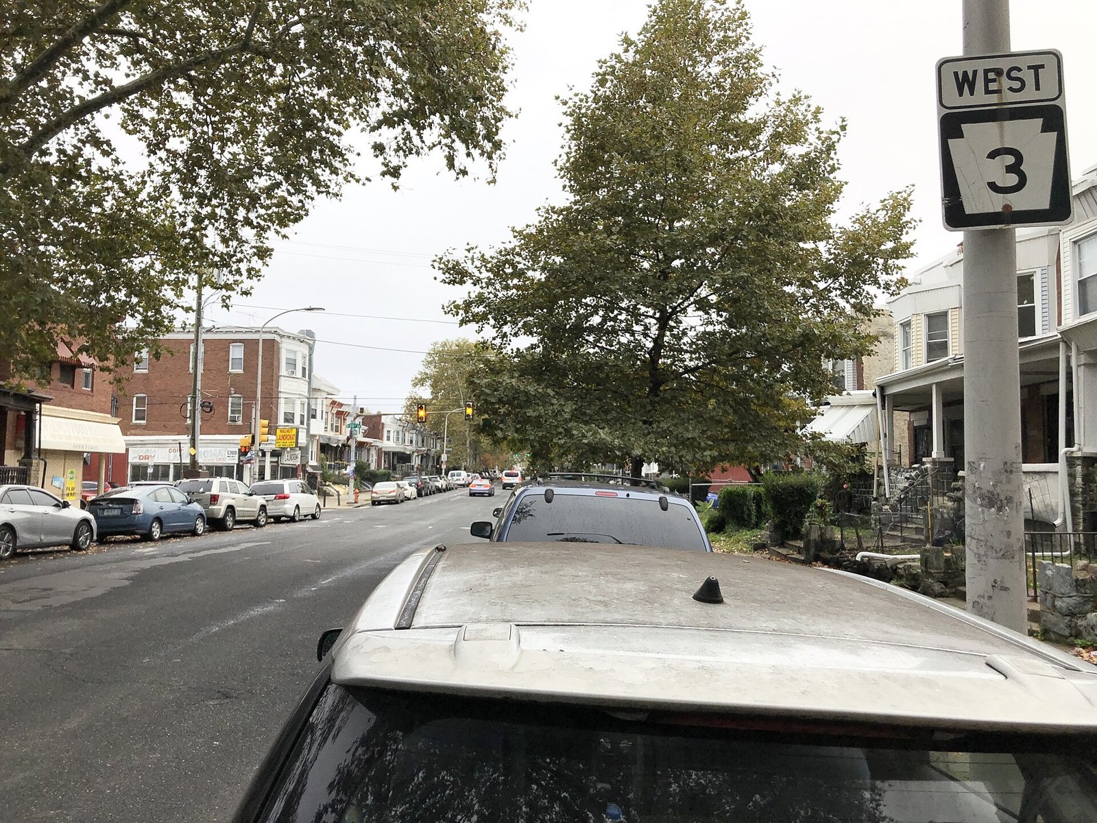 Walnut Street lined with rowhouses and trees in West Philadelphia